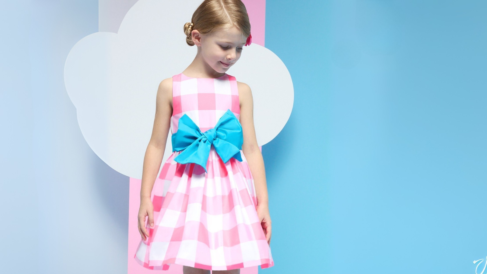 Young girl in elegant birthday dress for girls, twirling in soft natural light during celebration