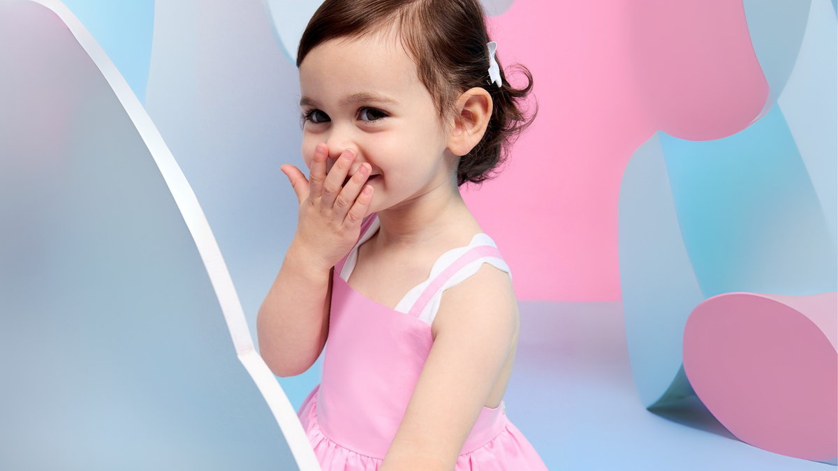 Fashion entrepreneur with luxury children's clothing showcasing premium kidswear brands available in India