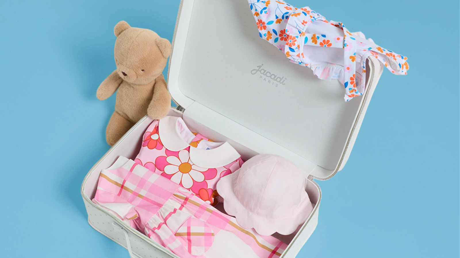 Elegant luxury baby clothes displayed in soft natural lighting, featuring premium newborn gift options